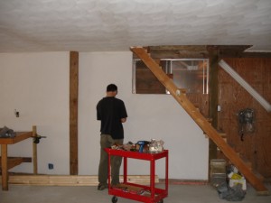 Adam installing outlets. Those are the stairs that lead up to the office! 