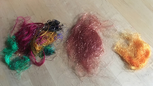 From L-R: Recycled Sari Silk Threads, Angelina Sparkles, and Dyed Firestar Fibers.
