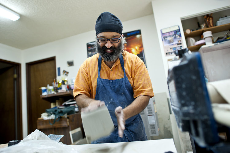 Charan Sachar working with clay